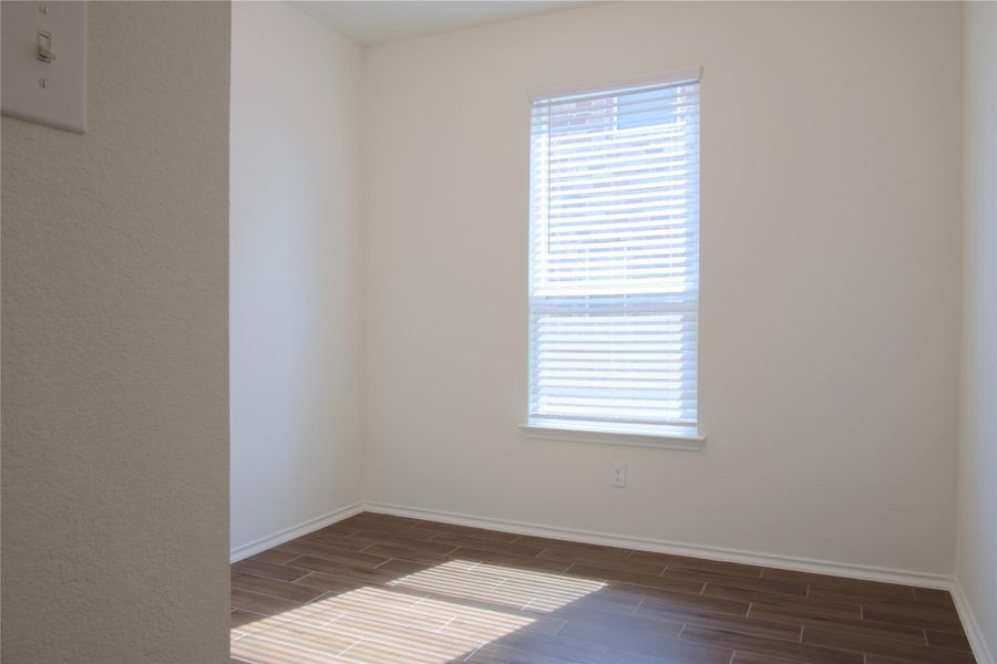 The wood-look tile flooring in this room provides a warm and durable foundation for any design.