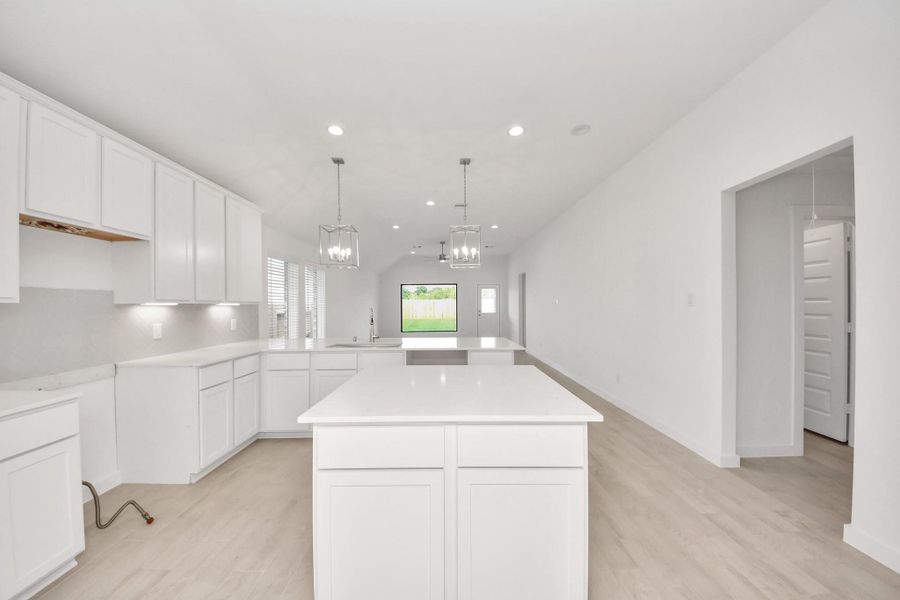 The extended counter area adds both practicality and style, making meal preparation a breeze. Every detail is thoughtfully designed to enhance the kitchen's functionality and aesthetic appeal. Sample photo of completed home with similar floor plan. Actual colors and selections may vary. The extended counter area adds both practicality and style, making meal preparation a breeze. Every detail is thoughtfully designed to enhance the kitchen's functionality and aesthetic appeal. Sample photo of completed home with similar floor plan. Actual colors and selections may vary.
