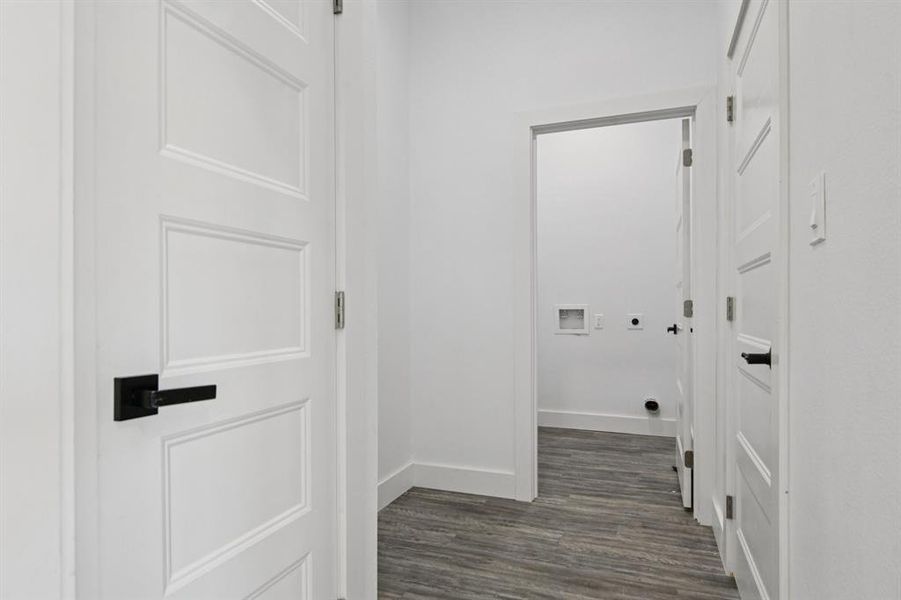 Washroom with dark wood-style flooring, hookup for a washing machine, and electric dryer hookup Washroom with dark wood-style flooring, hookup for a washing machine, and electric dryer hookup