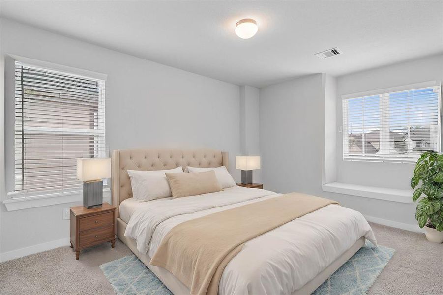 Secondary bedroom features plush carpet, custom paint, high ceilings, and large windows with privacy blinds.