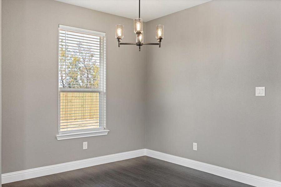 Dining Area with dark hardwood / wood-style flooring and a notable chandelier