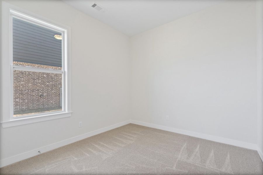Carpeted spare room with baseboards