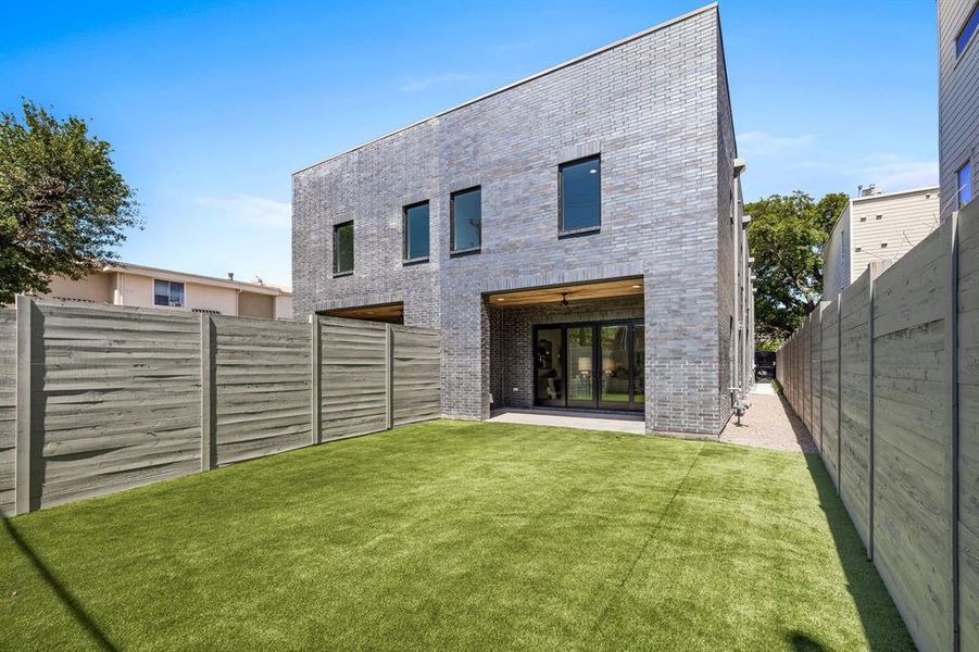 Rear view of property with a patio area and a lawn