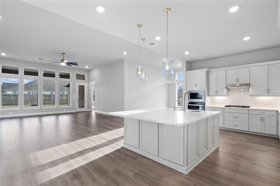 Walking into this expansive open-concept space, one immediately feels a sense of grandeur and tranquility thanks to the soaring ceilings and an abundance of natural light streaming through the massive all of windows.