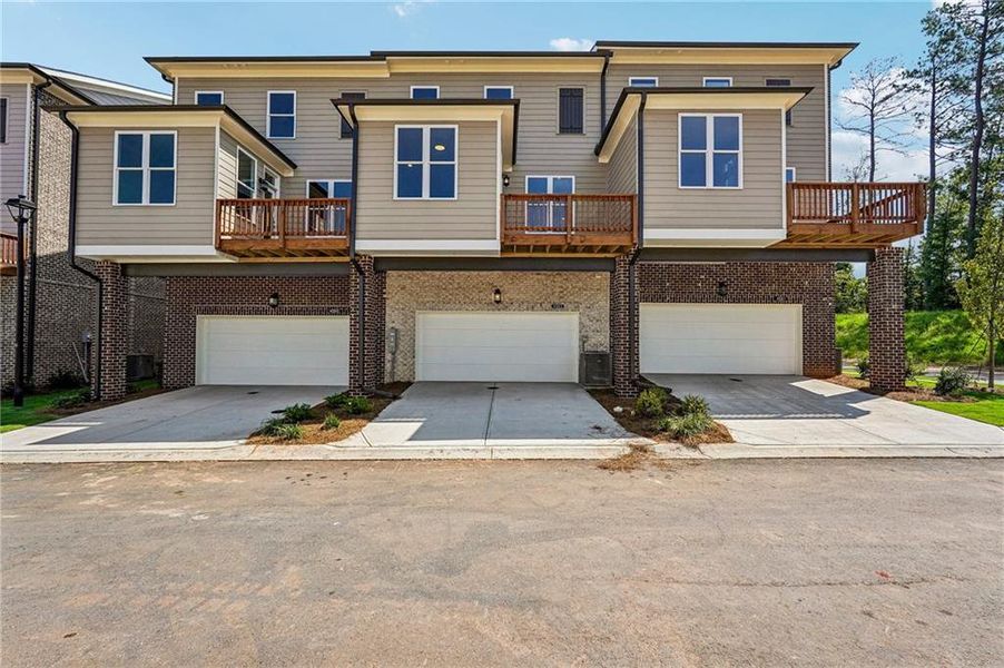 Front exterior of a new home in Waterside Townhomes, Peachtree Corners, GA, highlighting curb appeal (Image 2). Front exterior of a new home in Waterside Townhomes, Peachtree Corners, GA, highlighting curb appeal (Image 2).