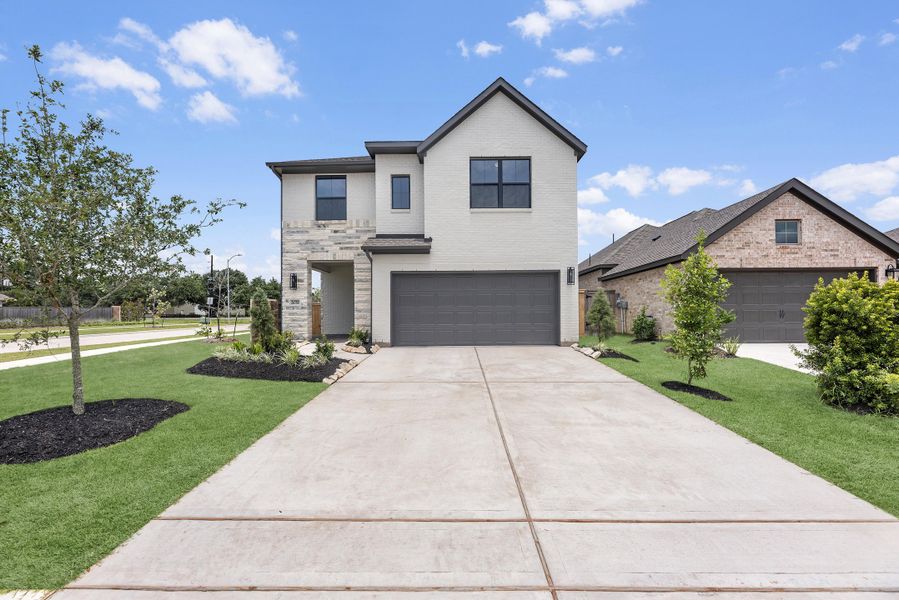 Front exterior of a new home in Candela, Richmond, TX, highlighting curb appeal (Image 2). Front exterior of a new home in Candela, Richmond, TX, highlighting curb appeal (Image 2).