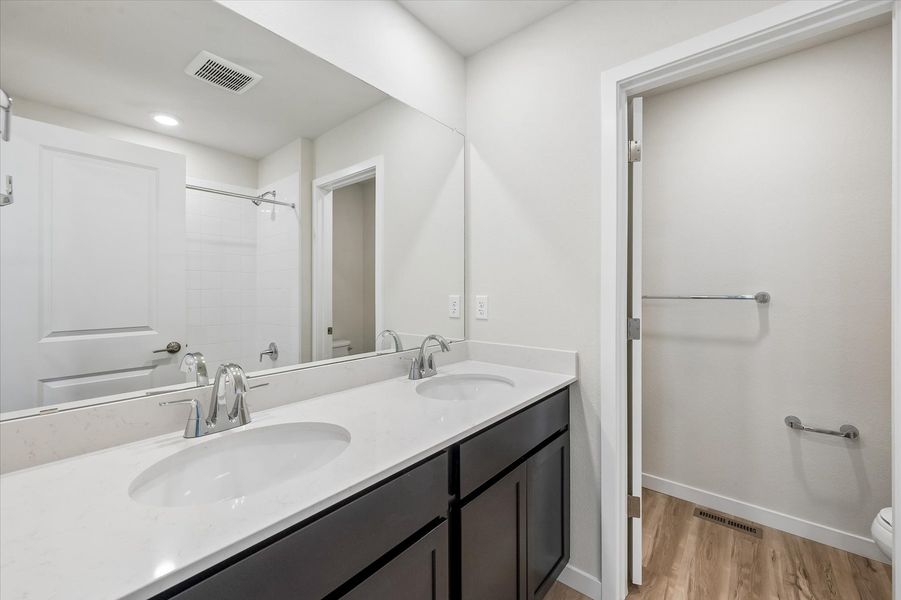 A bathroom with a sink and a shower.