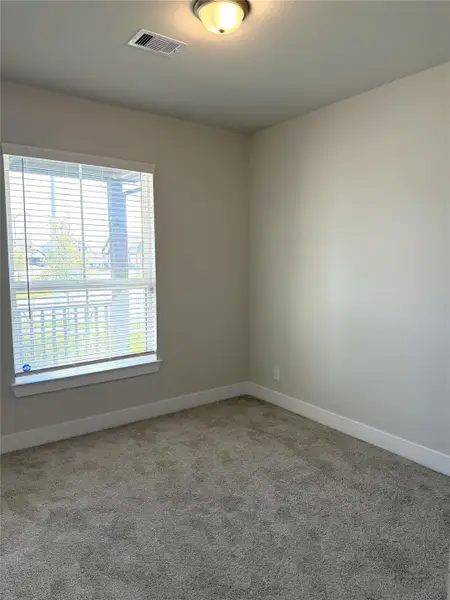 Versatile space perfect for a bedroom, home office, or private retreat—with a front porch view!