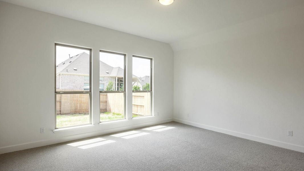 Spare room featuring healthy amount of natural light and carpet Spare room featuring healthy amount of natural light and carpet