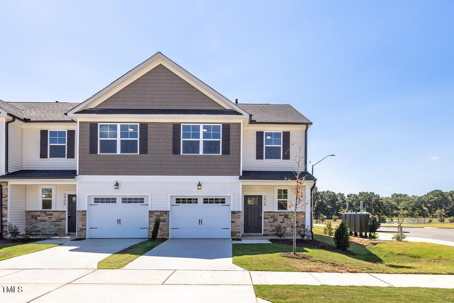 Front exterior of a new home in Springvale, Fuquay Varina, NC, highlighting curb appeal (Image 1).