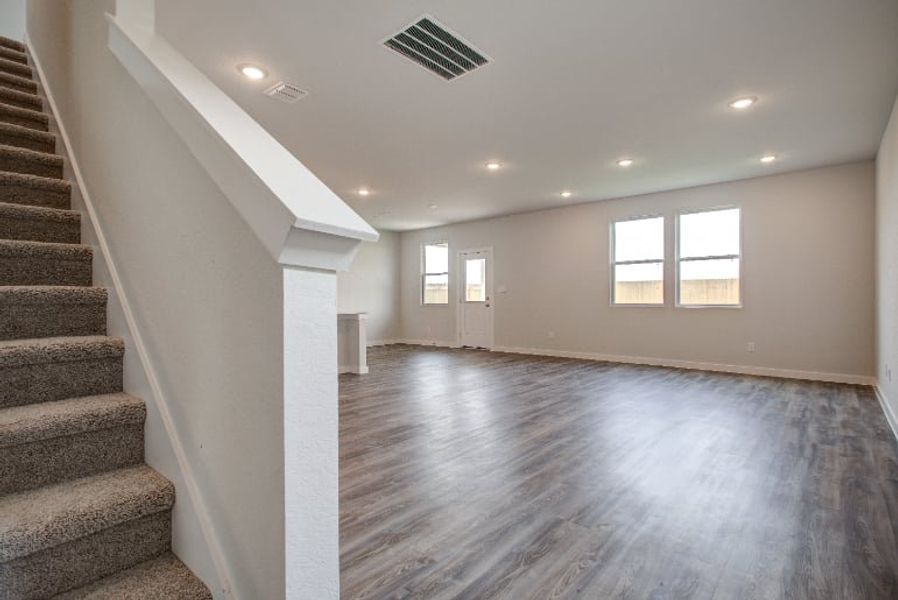 A long hallway with a wood floor. A long hallway with a wood floor.