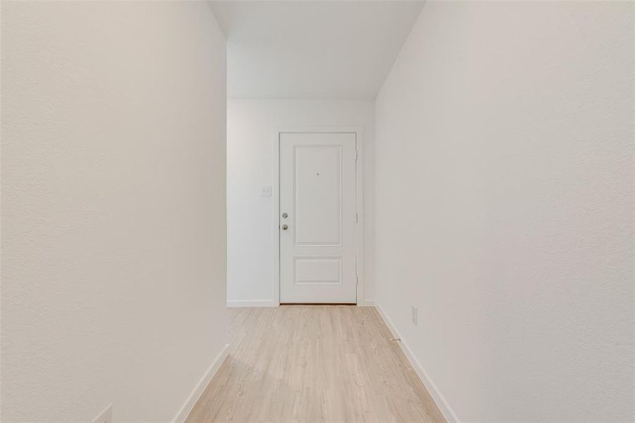 Corridor with light hardwood / wood-style floors