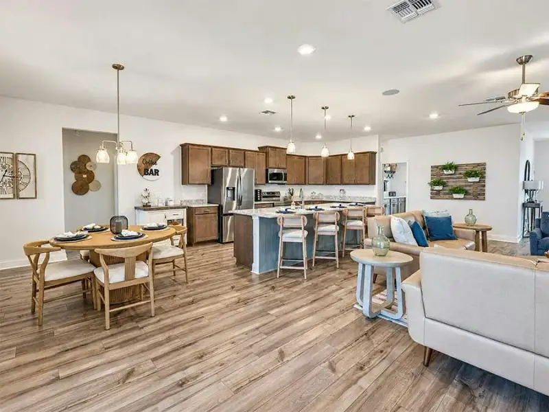 A cafe and counter-height island provide dining space - Waylyn by Highland Homes