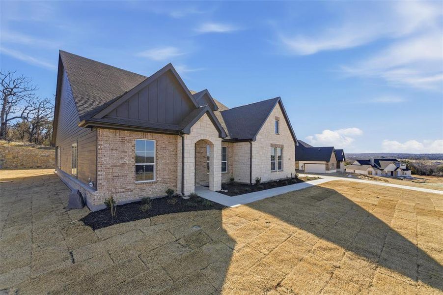 Front exterior of a new home in Oak Grove Addition, Springtown, TX, highlighting curb appeal (Image 20).