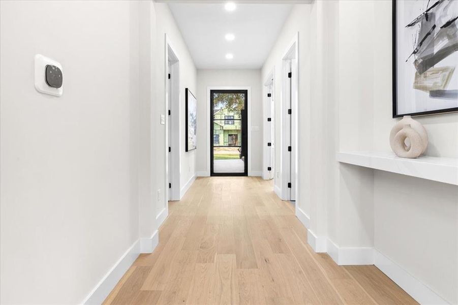 Hall with light hardwood / wood-style floors