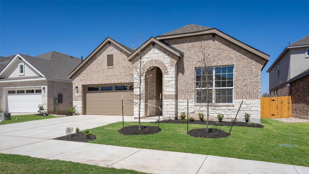 Front exterior of a new home in Rosenbusch Ranch, Leander, TX, highlighting curb appeal (Image 20). Front exterior of a new home in Rosenbusch Ranch, Leander, TX, highlighting curb appeal (Image 20).