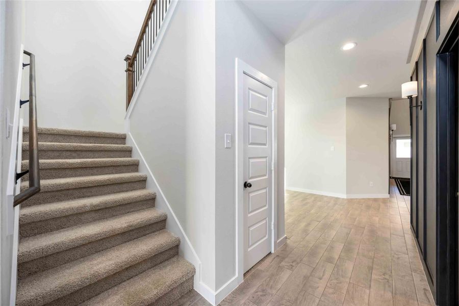 Staircase second view highlighting wood treads and modern railing. Staircase second view highlighting wood treads and modern railing.