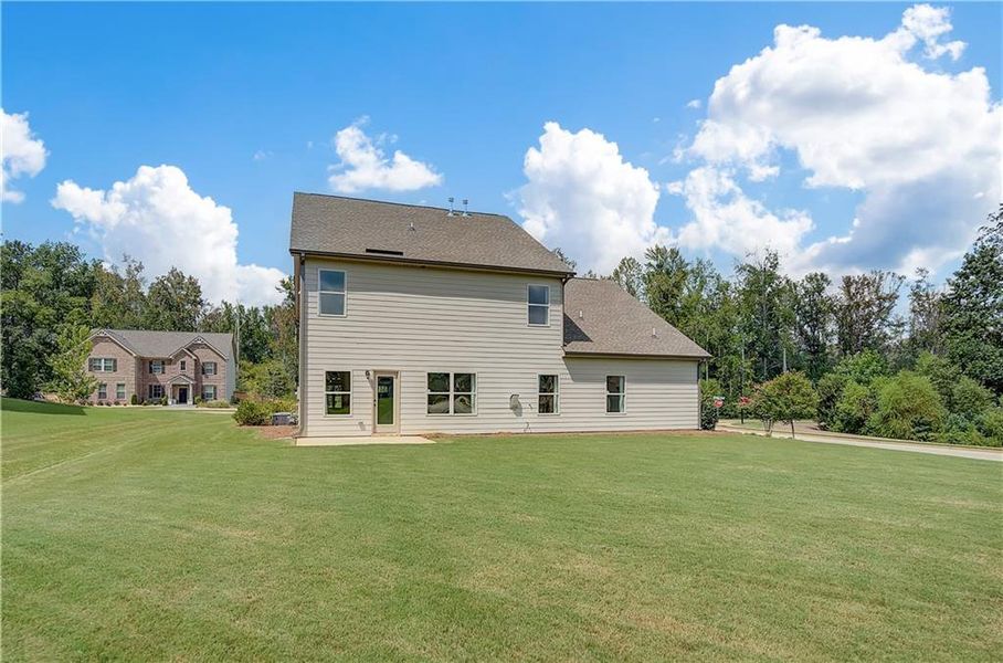 Front exterior of a new home in Traditions at Crystal Lake, Hampton, GA, highlighting curb appeal (Image 17). Front exterior of a new home in Traditions at Crystal Lake, Hampton, GA, highlighting curb appeal (Image 17).