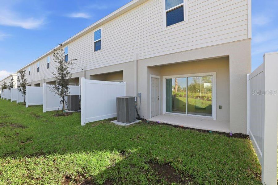 Exterior details and patio area of a home in The Towns at Firethorn, Parrish (Image 28).