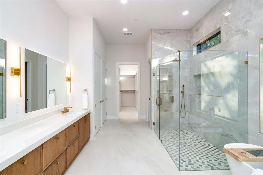 Bathroom featuring vanity and a shower with shower door