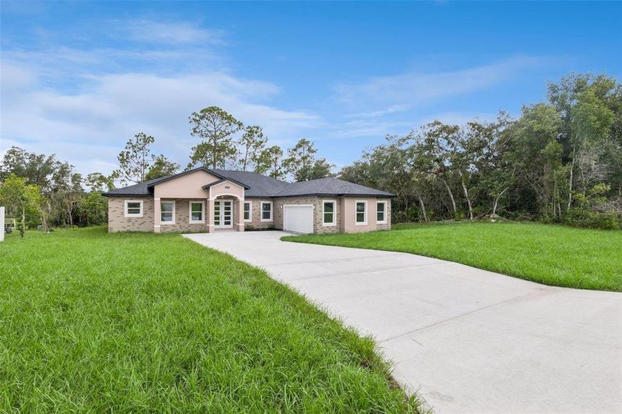 Front exterior of a new home in , Deltona, FL, highlighting curb appeal (Image 2). Front exterior of a new home in , Deltona, FL, highlighting curb appeal (Image 2).
