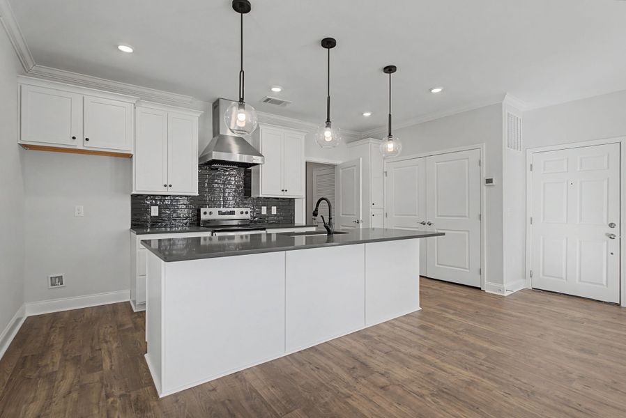 Carothers Farms Town Center Homes (Condos) Kitchen with Tile Back Splash and Vented Hood