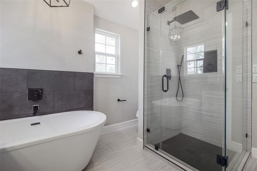 Soak off the day's stress in the deep soaking tub and enjoy a large, frameless, glass-enclosed walk-in shower with gorgeous tile surround.