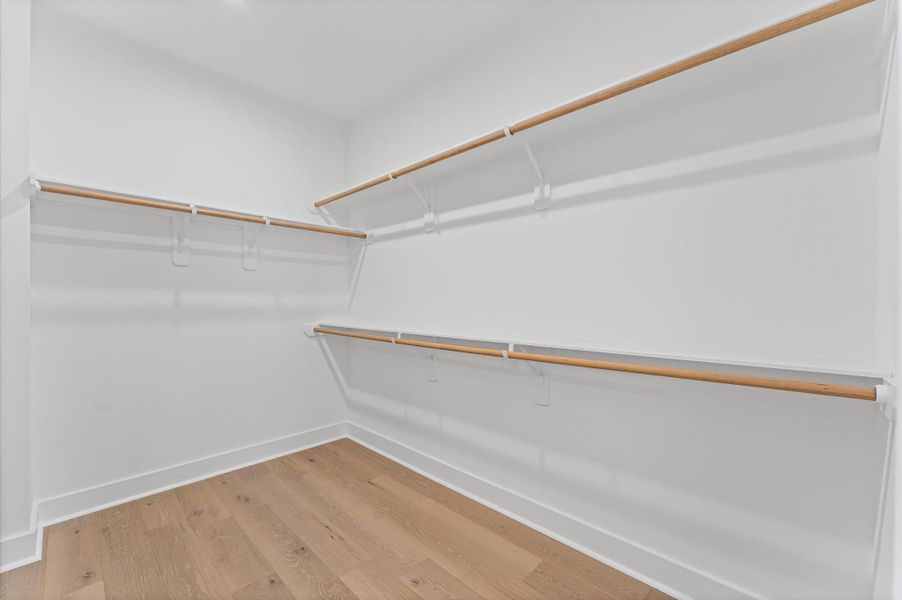 This well-proportioned primary closet offers a practical blend of space and organization, ideal for everyday use. With ample room for hanging garments and shelving for folded items or accessories, it balances functionality with comfort.