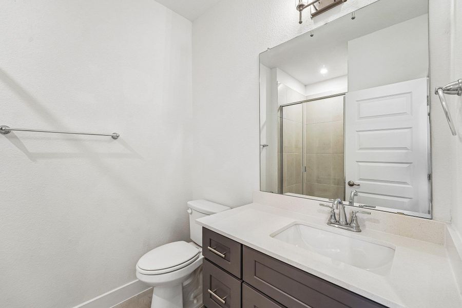 The guest bathroom features a quartz vanity and walk-in shower. The guest bathroom features a quartz vanity and walk-in shower.