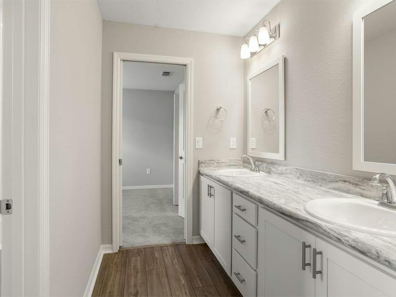 A dual-vanity Jack-and-Jill bath serves bedrooms 2 and 3 - Seabrooke ll by Highland Homes