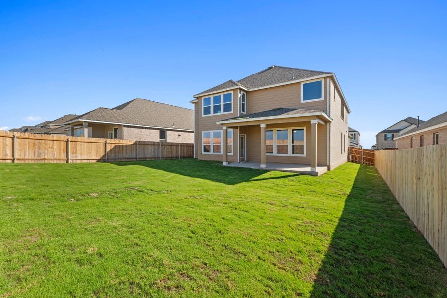 Front exterior of a new home in Salerno - Classic Collection, Round Rock, TX, highlighting curb appeal (Image 19). Front exterior of a new home in Salerno - Classic Collection, Round Rock, TX, highlighting curb appeal (Image 19).