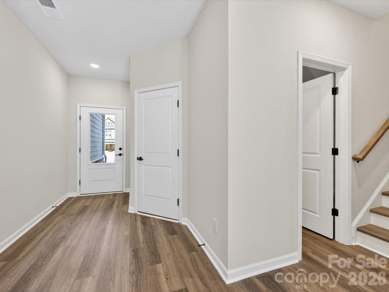 Foyer entrance to the home, LVP flooring throughout the first floor and LVP stairs to the second floor