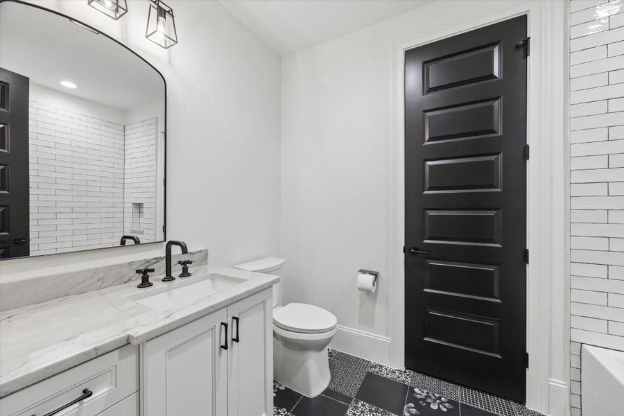 Timeless finishes, quality cabinetry, and elegant details elevate this beautifully appointed bath, reflecting the same exceptional craftsmanship found throughout the residence.