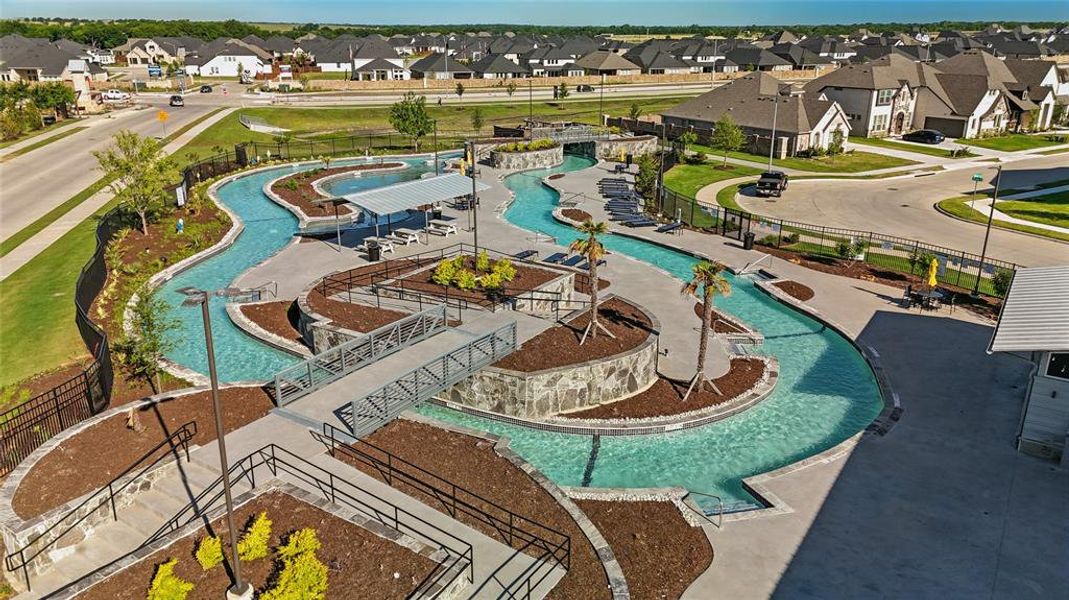 Community lazy river amenity featuring multiple bridges and integrated seating areas