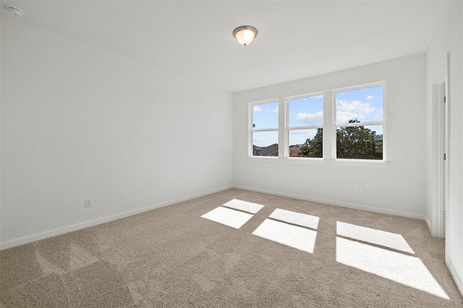 Empty room with light colored carpet and baseboards Empty room with light colored carpet and baseboards