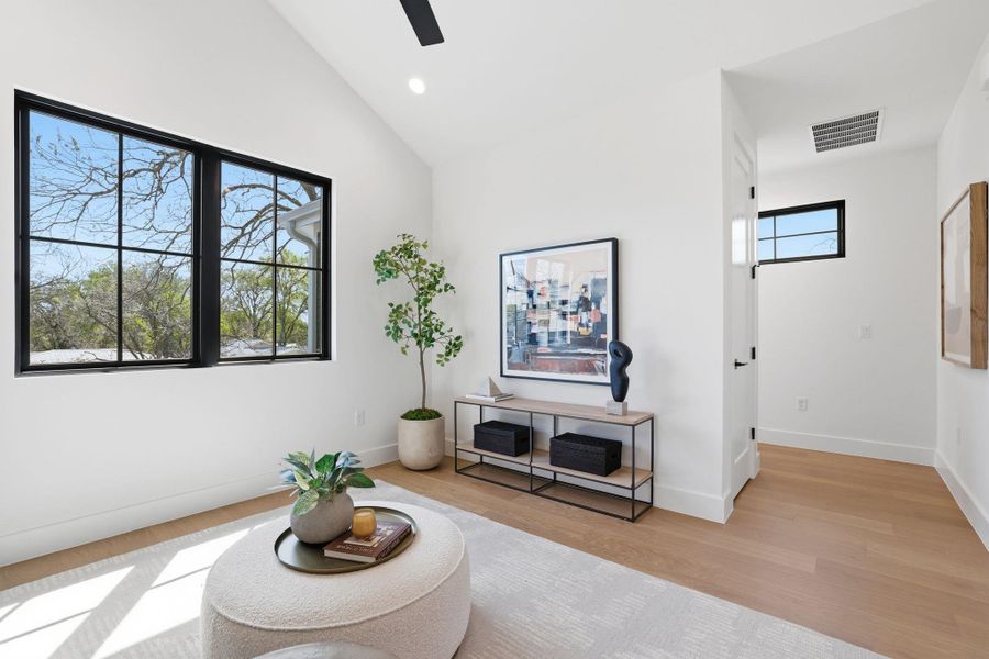 Sitting room featuring light wood-style flooring, vaulted ceiling, a ceiling fan, and recessed lighting