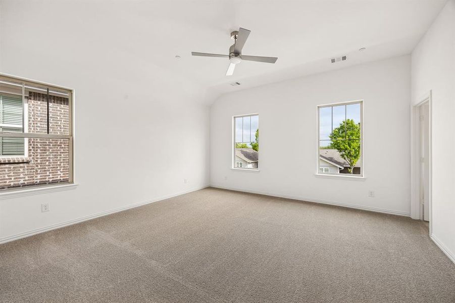 A spacious owner's suite that offers high ceilings, natural light from multiple windows, his & hers walk in closets....our Hansen floor plan has it all!