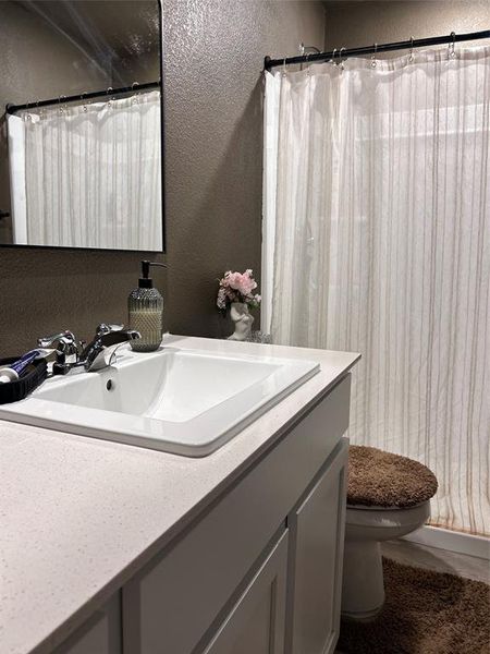 Full bath with a vanity, and a shower Full bath with a vanity, and a shower