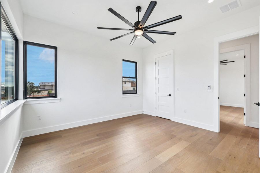 Unfurnished bedroom with light wood-style floors, a ceiling fan, and recessed lighting