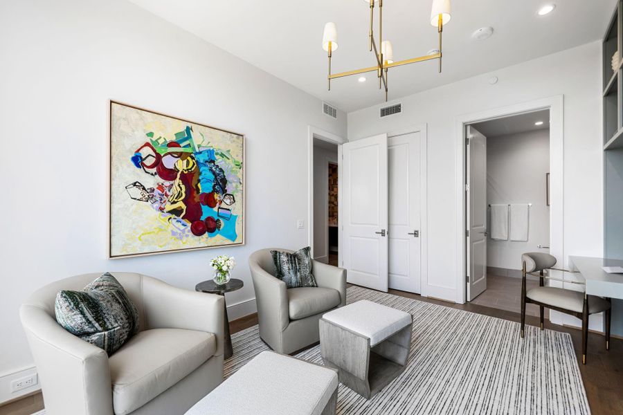 Another perspective of the secondary bedroom highlighting a dedicated space for relaxation. Photos are of a similar unit with the same floor plan