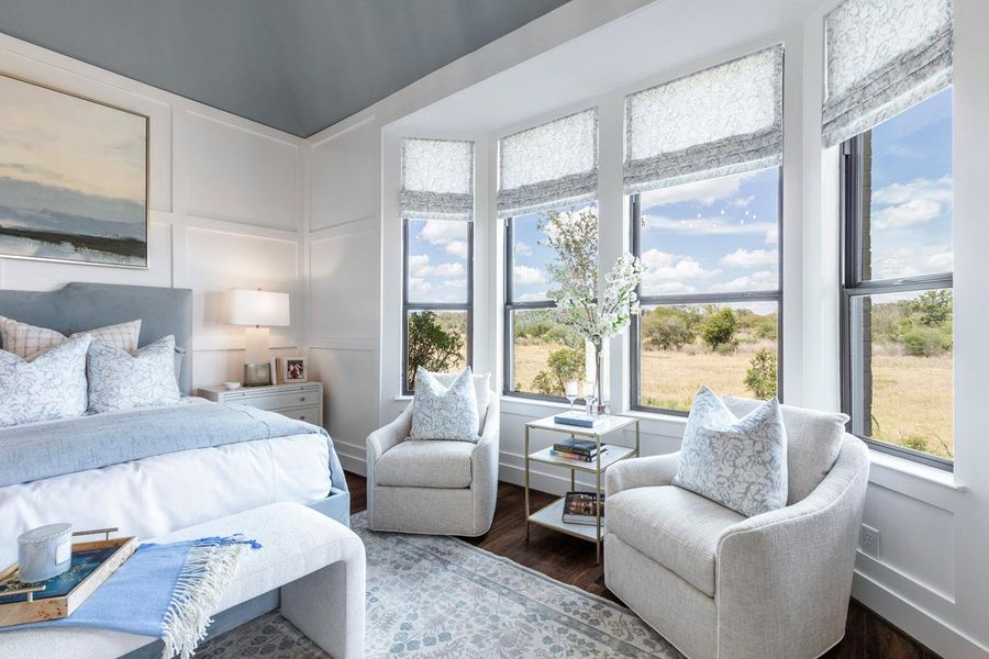 Bedroom featuring a decorative wall and wood finished floors Bedroom featuring a decorative wall and wood finished floors