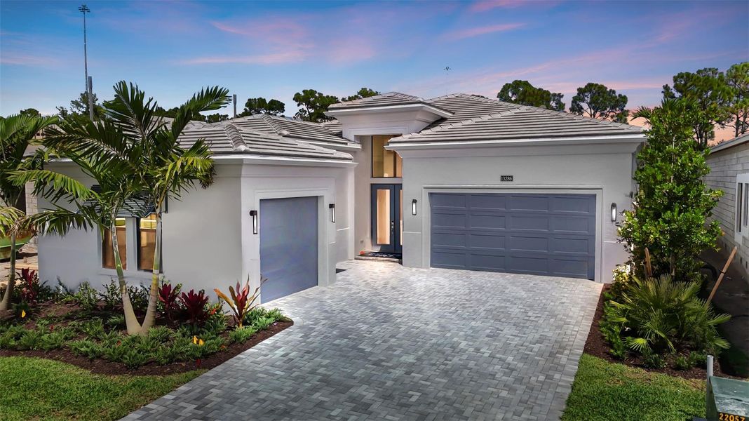 Front exterior of a new home in Artistry Palm Beach, Palm Beach Gardens, FL, highlighting curb appeal (Image 2).