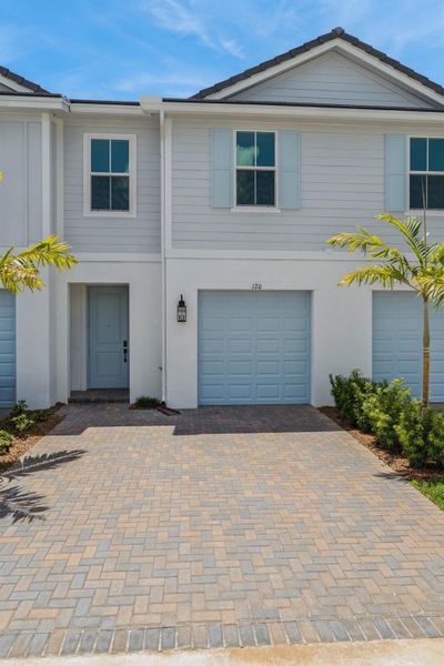 Front exterior of a new home in Salerno Reserve Townhomes, Stuart, FL, highlighting curb appeal (Image 20).