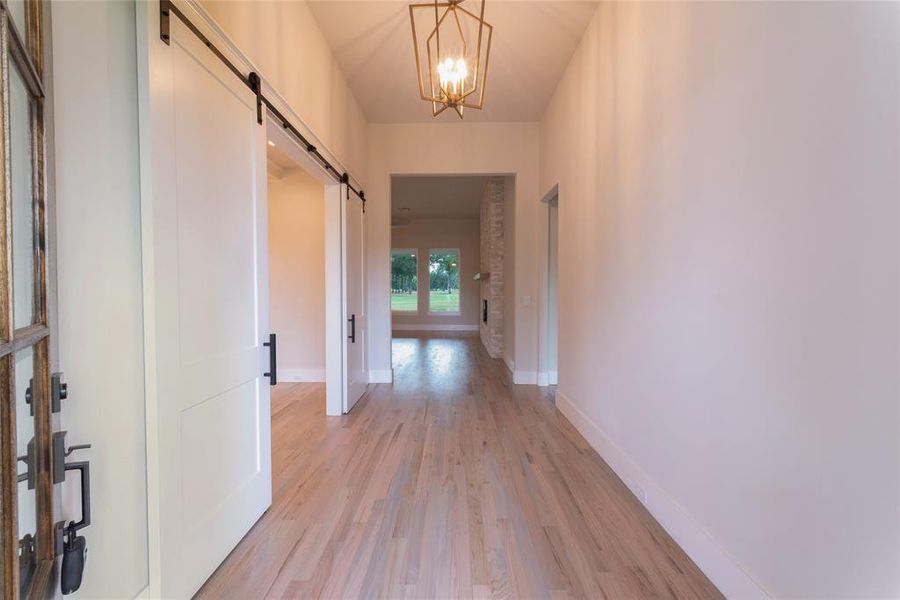 Entrance to foyer showing barn doors to study on the left.