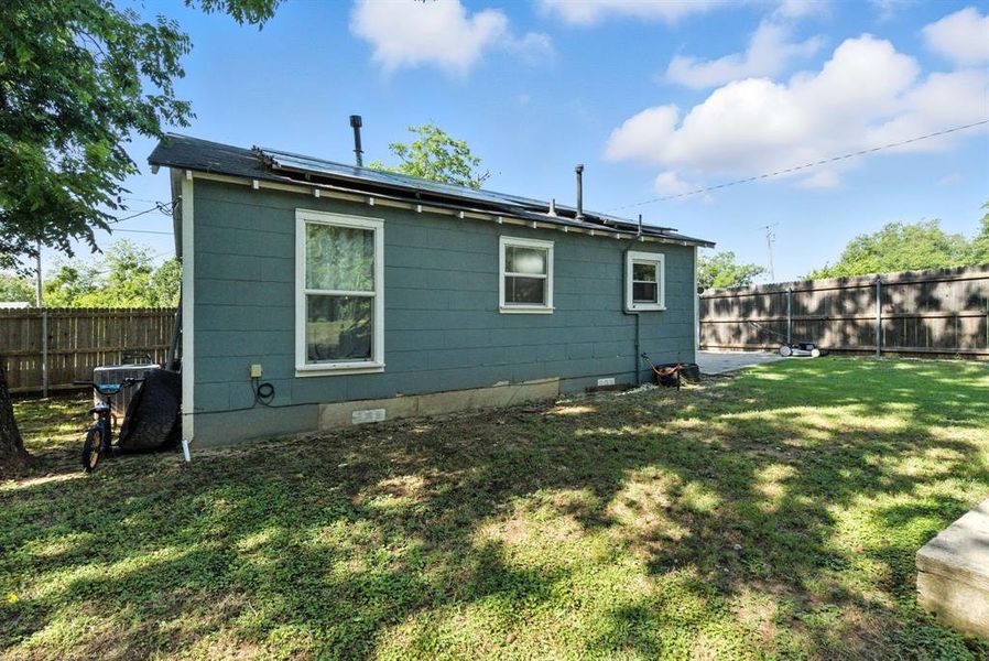 Back of house featuring crawl space and a fenced backyard