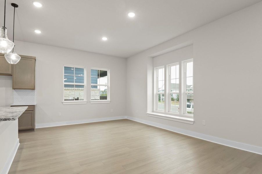 Unfurnished dining area with light wood-style flooring and recessed lighting