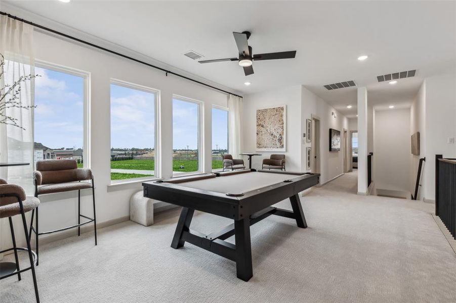 Entertaining is a breeze in this spacious, light filled game room!