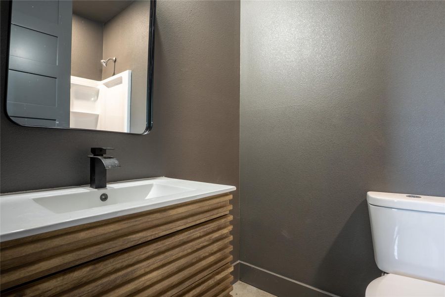 Bathroom featuring vanity and a textured wall