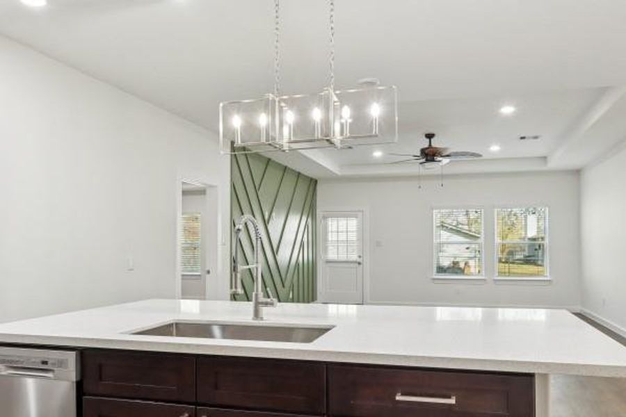 Modern central lighting enhances the kitchen's elegance and functionality. Modern central lighting enhances the kitchen's elegance and functionality.