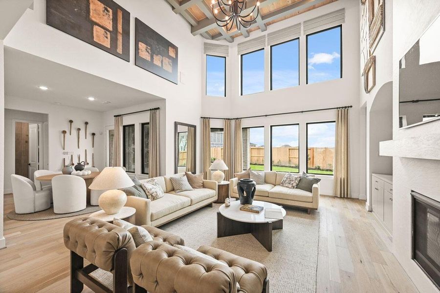 Soaring windows allow plenty of light into the family room. Representative image.